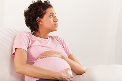 worried pregnant woman looking for pregnancy resources